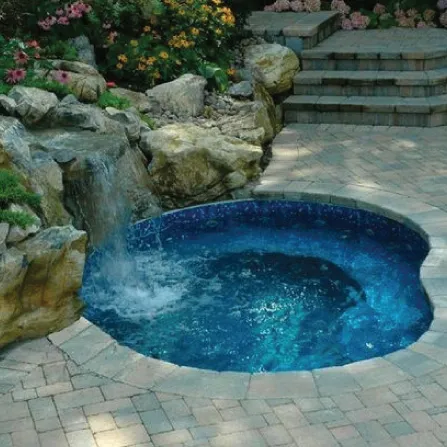 Crystal clear serviced swimming pool with spa spillway in Houston