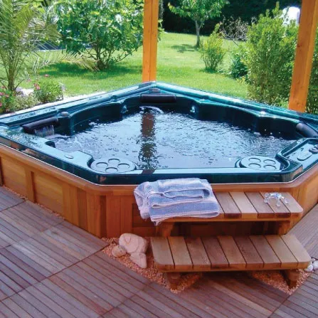 In ground hot tub adjoining a custom swimming pool in Houston