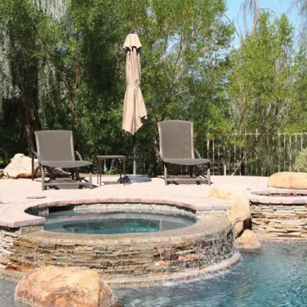 Illuminated custom pool and spa in a Houston backyard at night